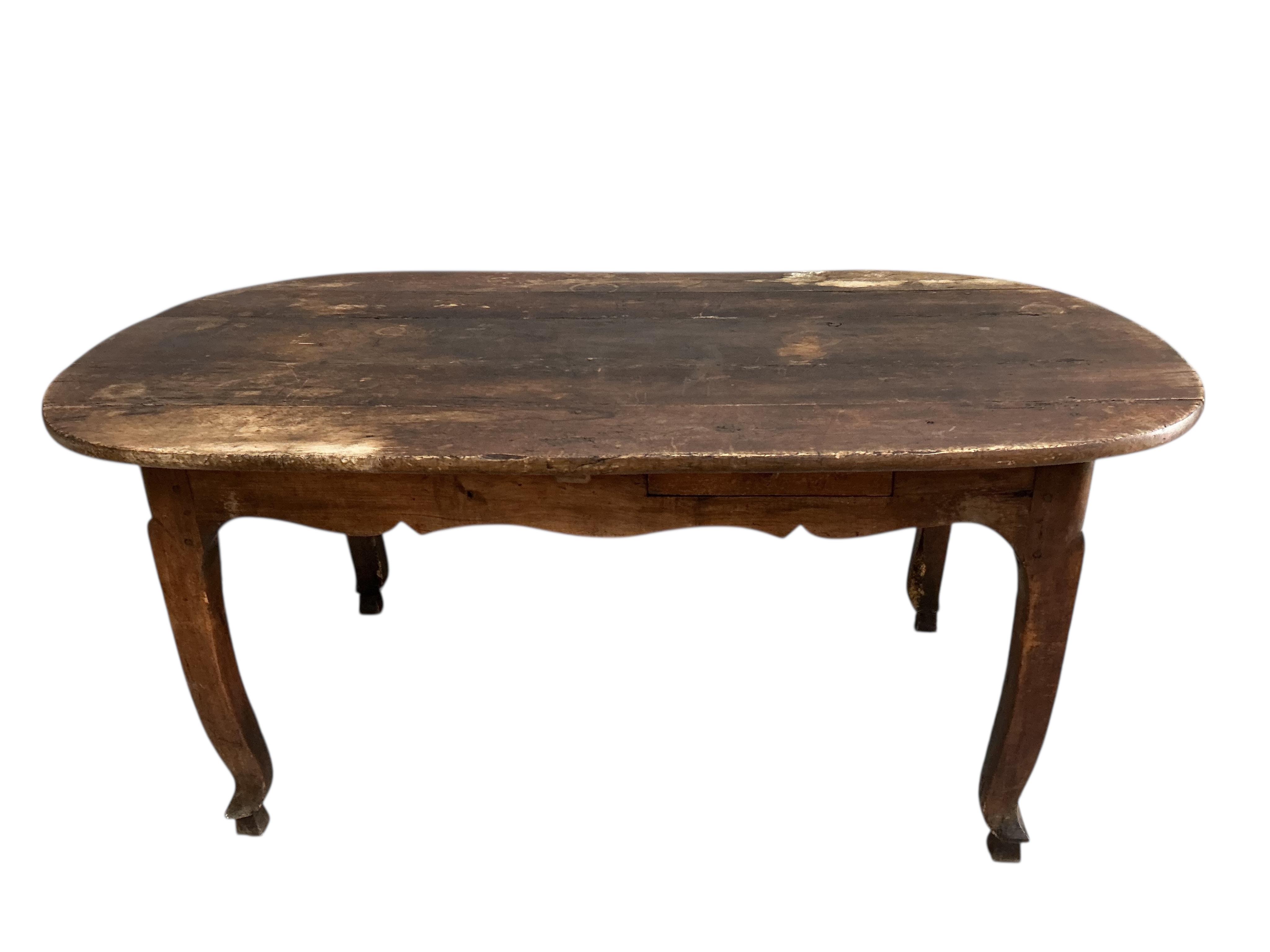 An early 19th century French Provincial oval fruitwood kitchen table, width 180cm, depth 104cm, height 77cm